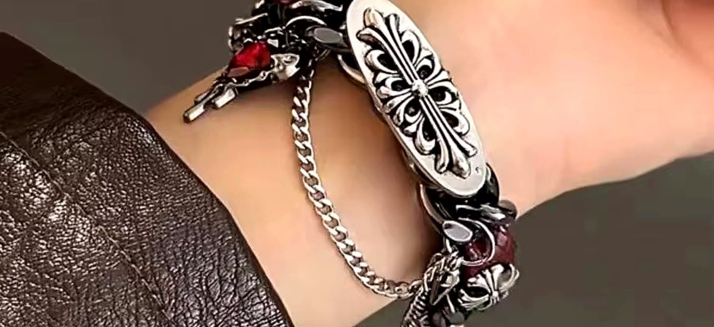 Chain bracelet with an engraved silver plate, worn with a leather jacket
